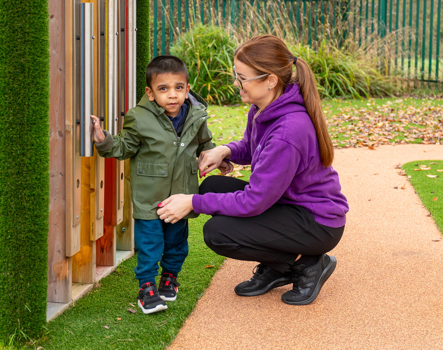el-1 staff member playing with child in the garden
